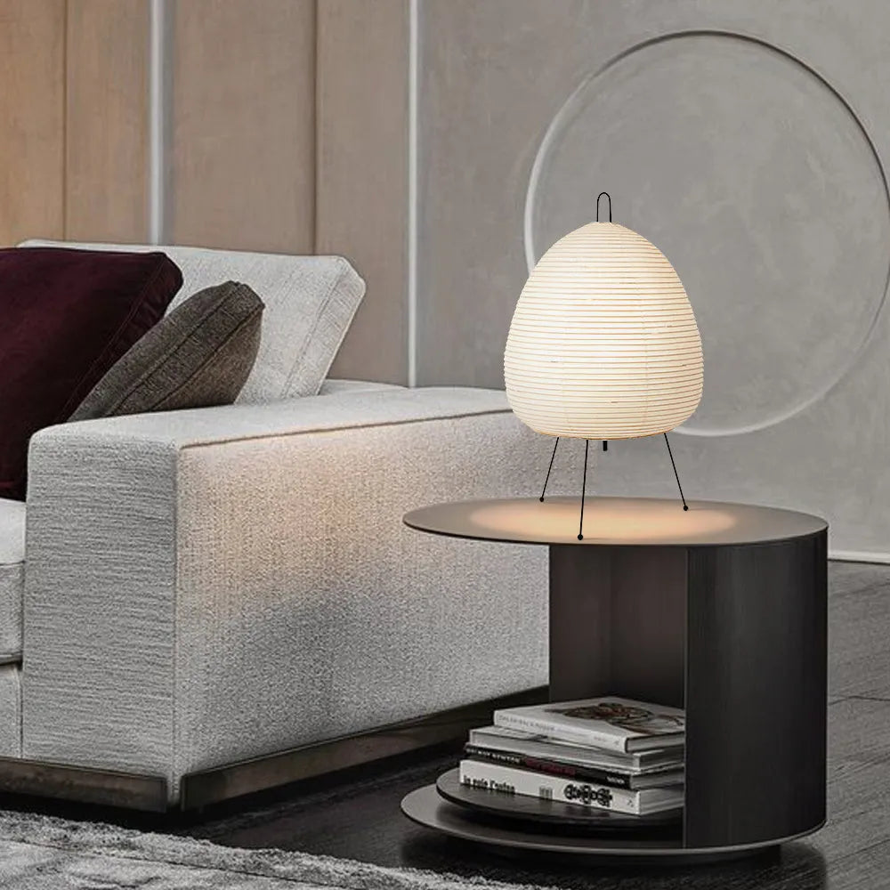 Japanese style table lamp with a white handmade rice paper shade on a slim aluminium base.