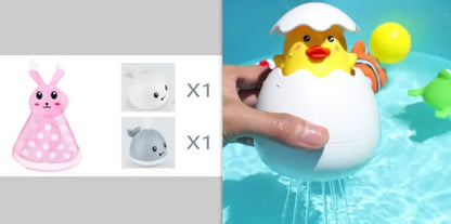 Grey or white electric whale bath toy spraying water with LED lights on a base.
