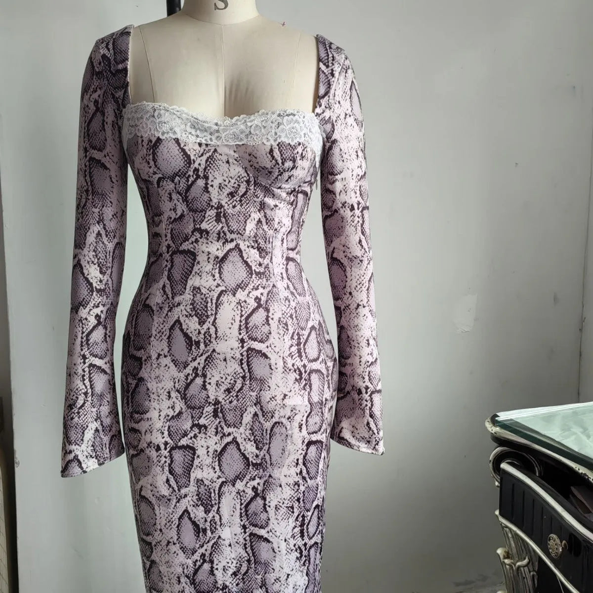 Grey lace dress with 3D floral digital print, A-line skirt, and long slim-fit sleeves on a mannequin.