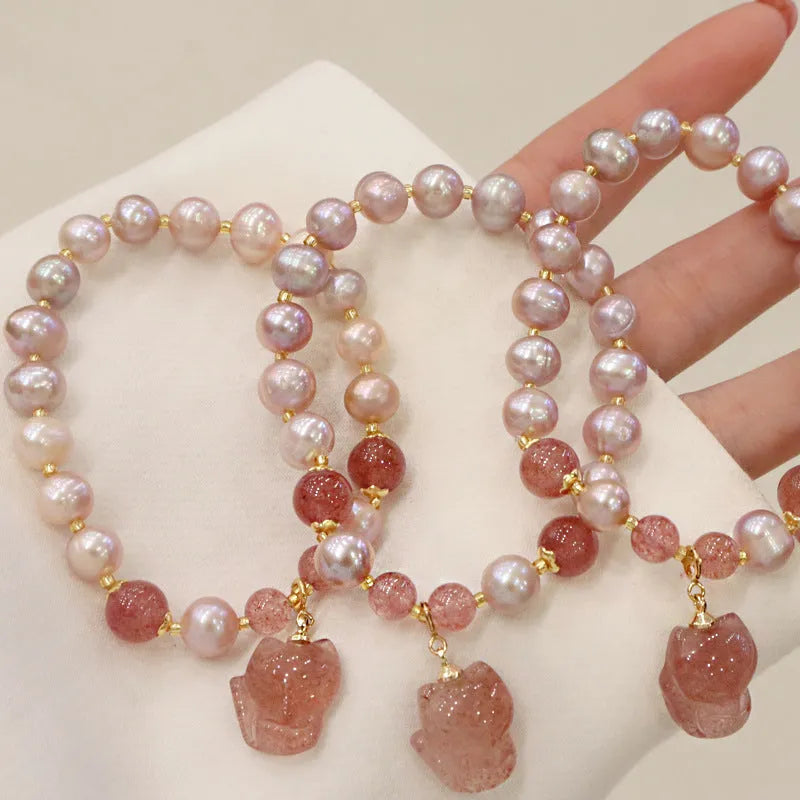 Women's versatile natural freshwater pearl bracelet with strawberry quartz and fox charm, an animal zodiac themed jewellery piece suitable for travel commemoration gifts and women's everyday styling.