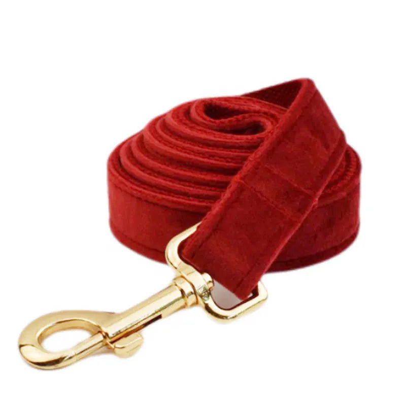Cloth dog collar set with matching leash, bow tie, vest, and poop bag accessories