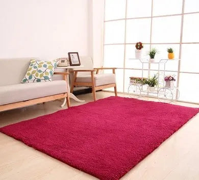 Solid colour plush rectangle area rug with soft texture on a wooden floor.