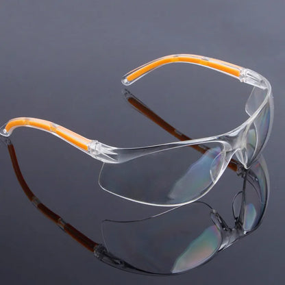 Transparent polycarbonate safety goggles with yellow frame for lab and welding protection.