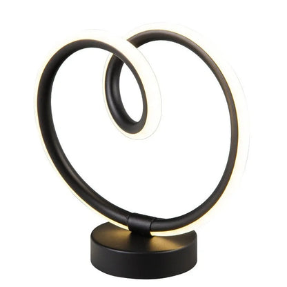 Black remote-controlled LED night light with Bluetooth remote on a bedside table.