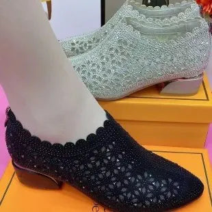 Women's chunky heel shoes with hollow-out upper, frosted full diamond detailing, round toe, canvas upper, and rubber sole.