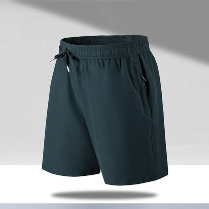 Man wearing black loose-fit quick-dry polyester sports shorts on a summer day.