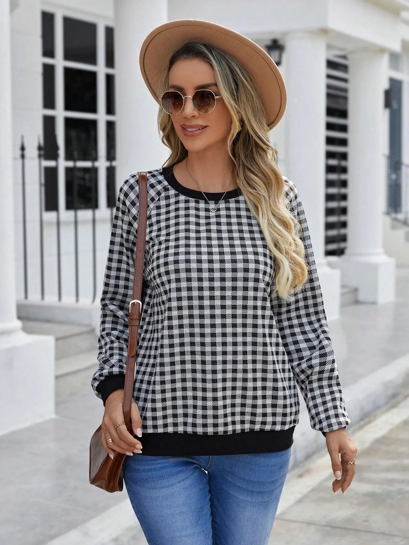 Black plaid pullover sweater with striped pattern and long sleeves, showing printing detail on polyester fabric