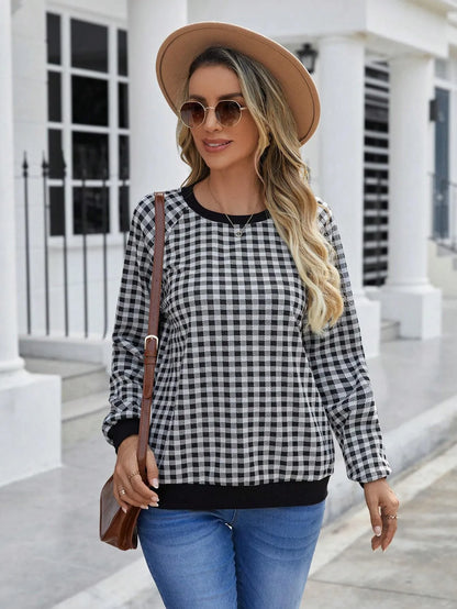 Black plaid pullover sweater with striped pattern and long sleeves, showing printing detail on polyester fabric