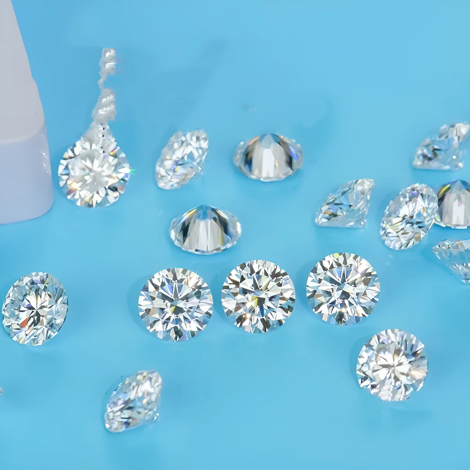 Round moissanite gem stone with eight hearts and eight arrows cut on a grey background