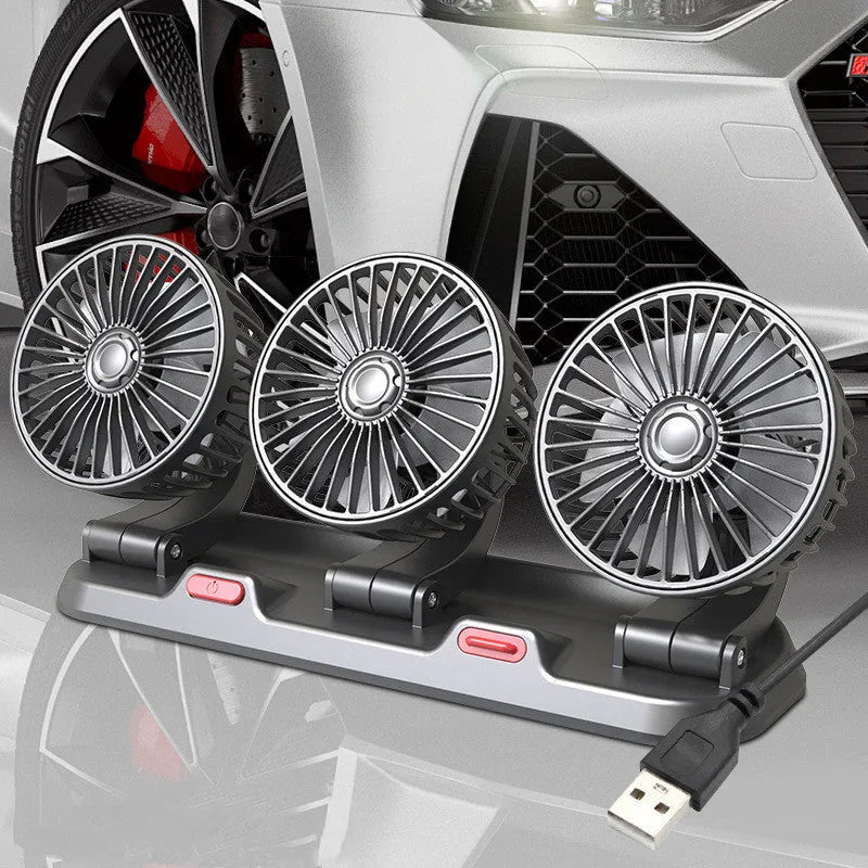 Three-head adjustable 12V car cooling fan with USB and cigarette lighter plugs on a dashboard.