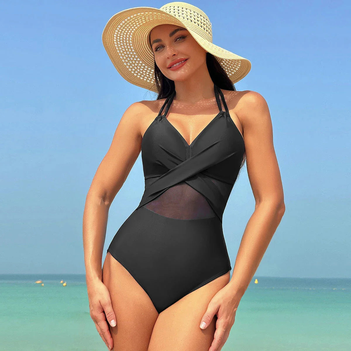 One-piece swimsuit with halter-neck and cross-strap design, available in various solid colors and a leopard print pattern