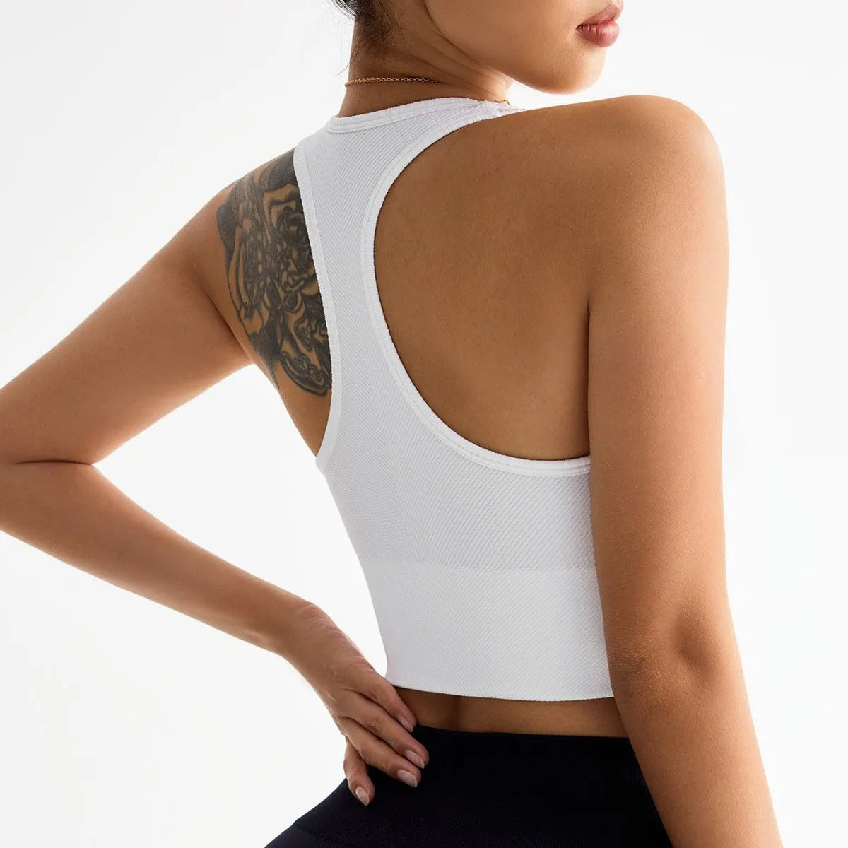 Black women's sports bra with fixed double shoulder straps and a full cup design on a mannequin.