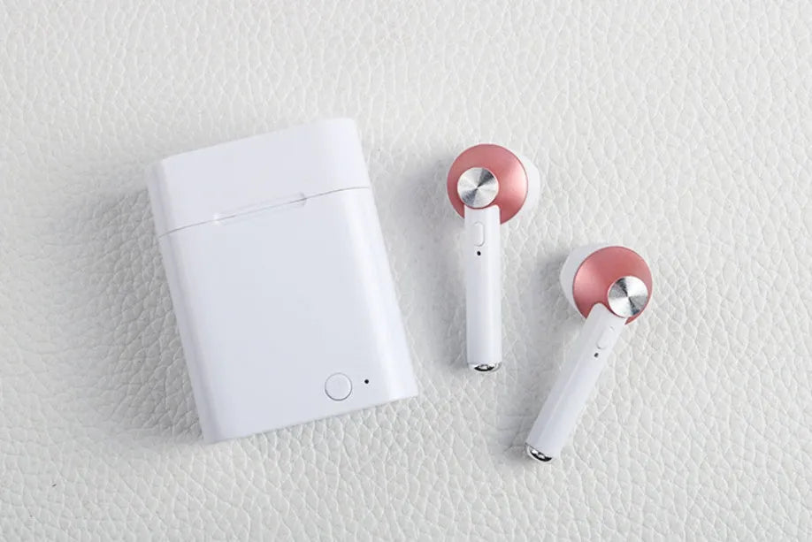 Black wireless sports Bluetooth earbuds showing battery display and placed next to a smartphone.