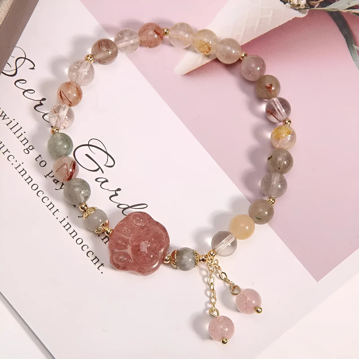 Colourful hair crystal stretch bracelet with cat's paw, butterfly, flower, and purse charms on adjustable band