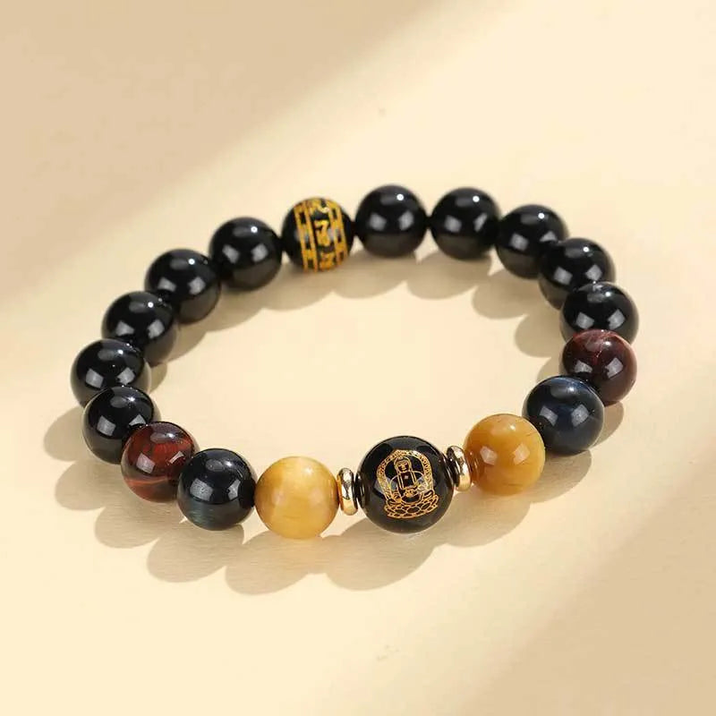 Handcrafted black agate and tiger eye stone beaded bracelet with a central carved zodiac deity charm.