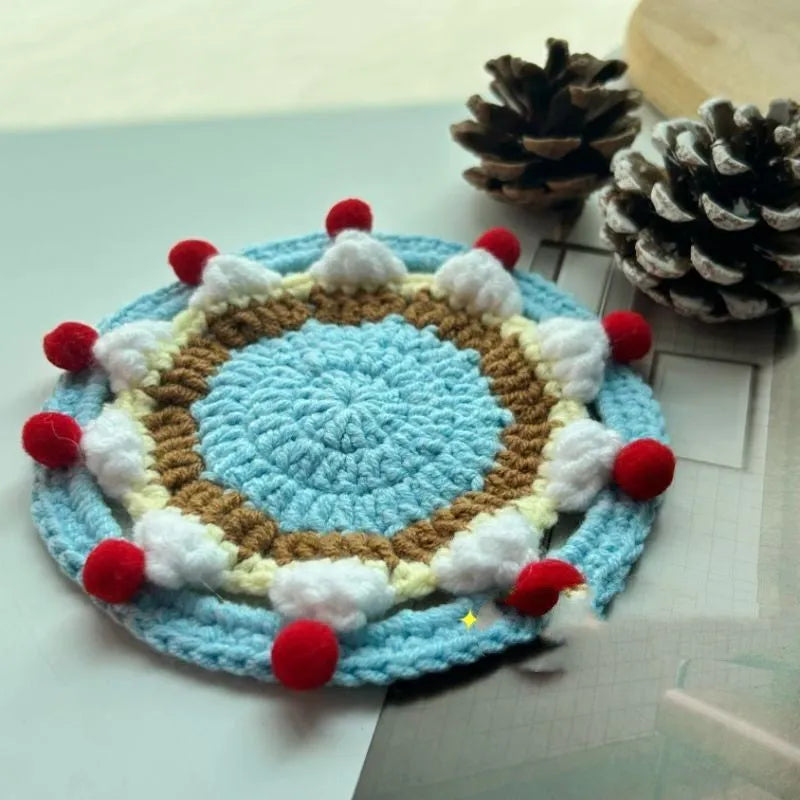 Finished wool crochet coaster bag with cake design measuring 9cm diameter