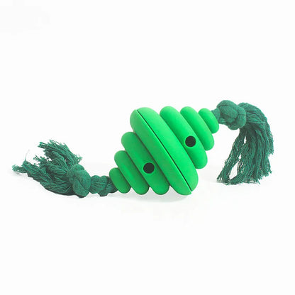 Green and yellow dog ball with attached knotted rope chew and feeder toy on grass.