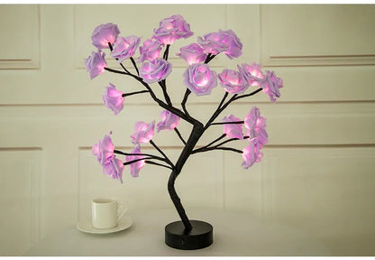 White and red rose flower LED lamp on a table with bonsai tree shape and warm white glow.