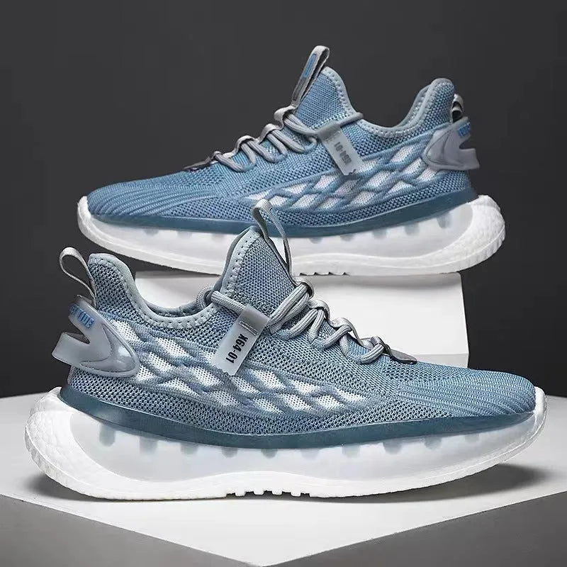 Men's white low-top sneakers with mesh upper and flat rubber sole on a grey background.