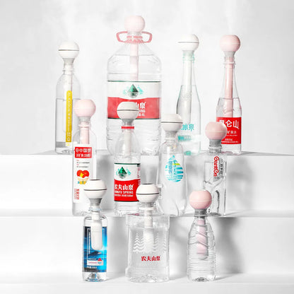 Pink and white columnar magic wand ultrasonic humidifier with USB cable and mechanical knob.