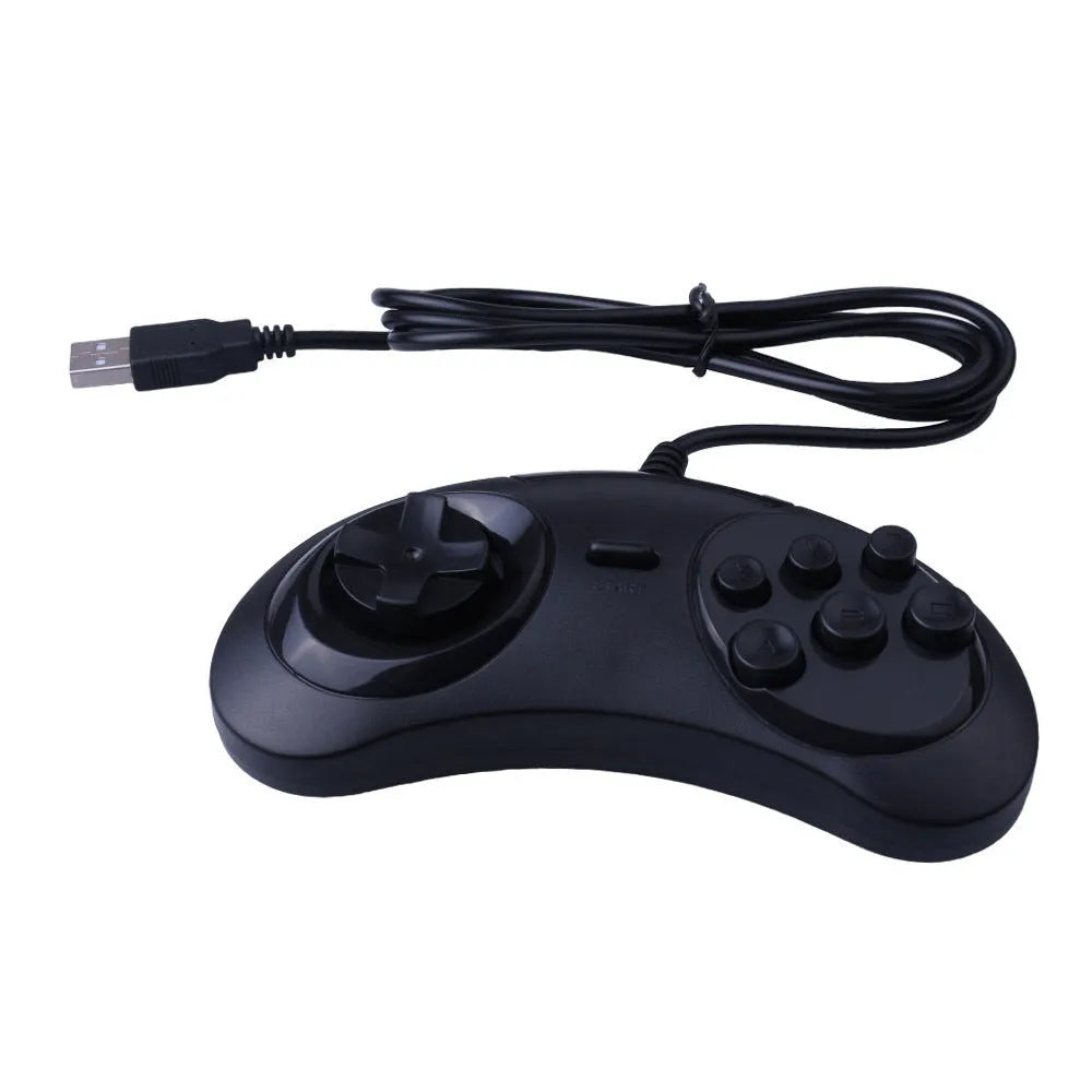 Black Sega USB PC game controller with 1.8m cable on a desk next to a laptop