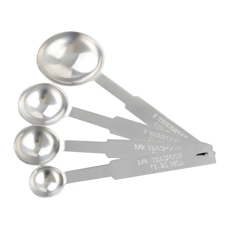 Set of six stainless steel measuring spoons connected by a silver D-ring, showing engraved measurement markings