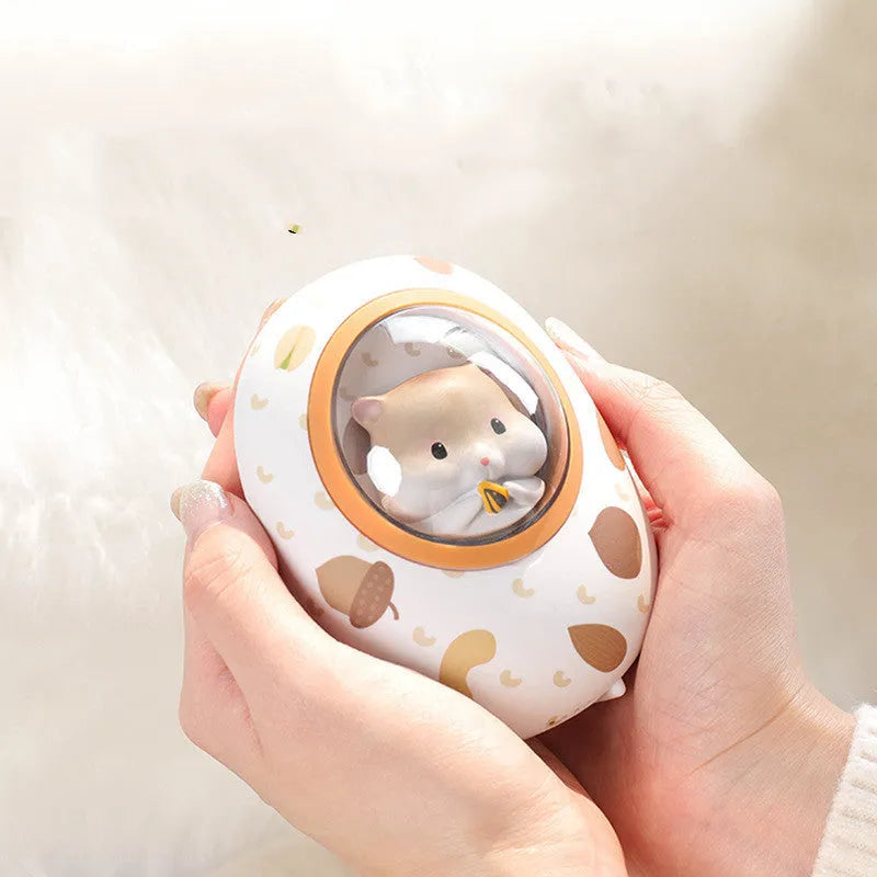White Hamster space capsule design hand warmer and 5000mAh USB power bank unit.