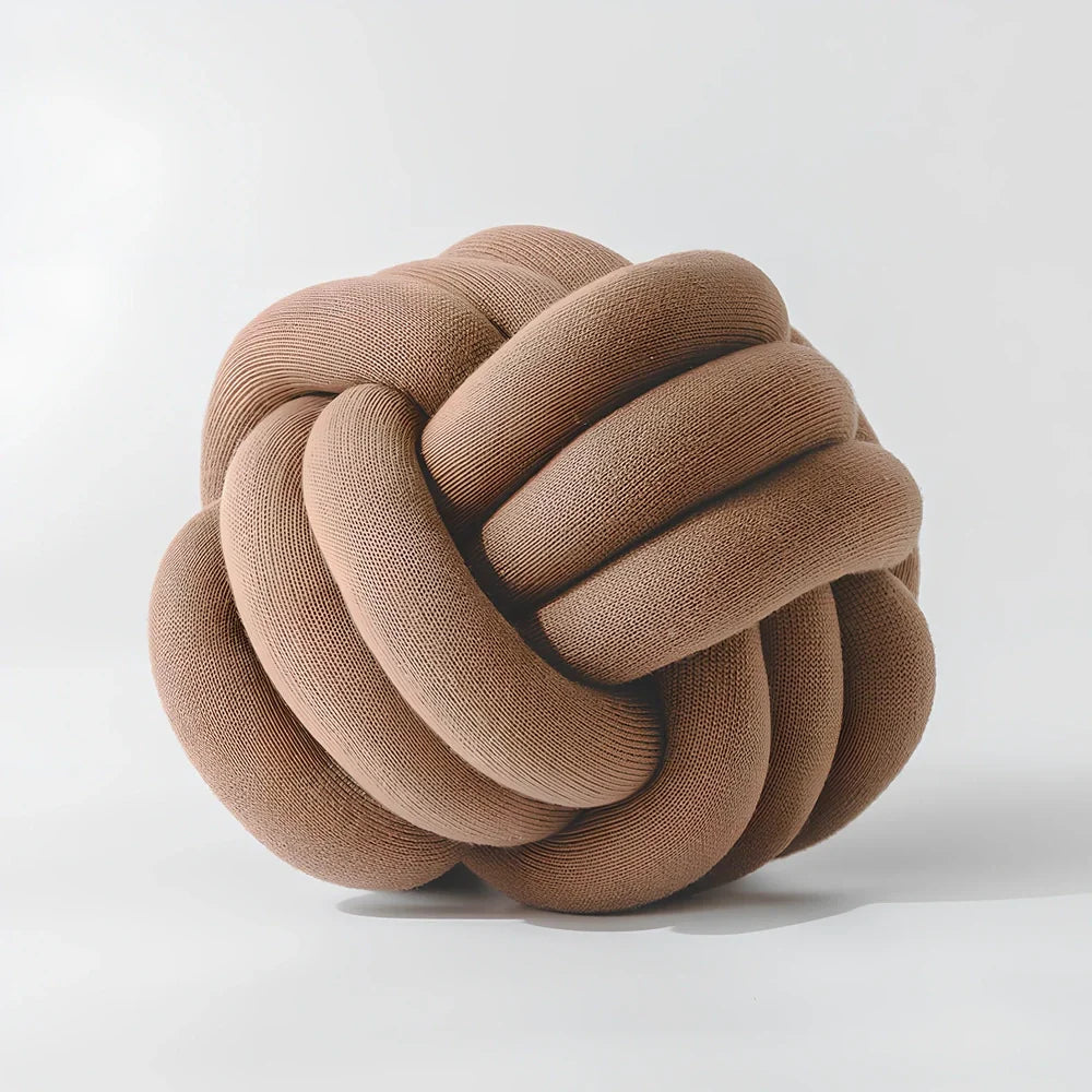 Knotted lumbar pillow with memory foam fill showing adjustable height feature and polyester cover