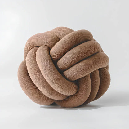Knotted lumbar pillow with memory foam fill showing adjustable height feature and polyester cover