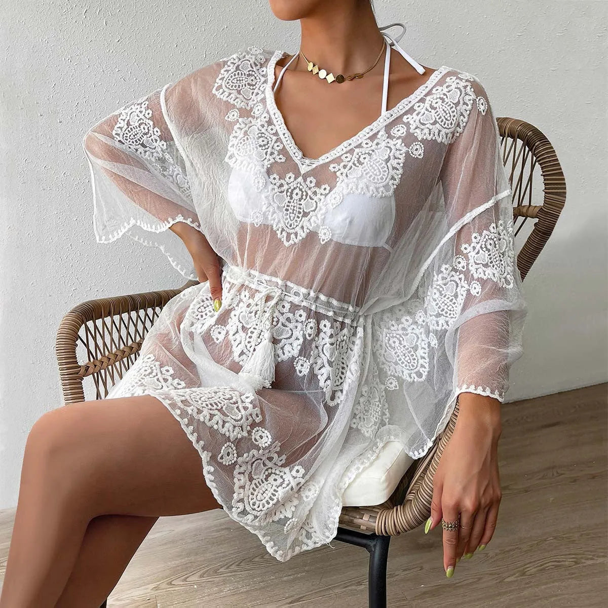 White women's water-soluble beach blouse with loose fit, shown as a swimsuit cover-up offering UPF 50+ protection.