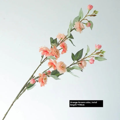 Artificial silk camellia flower in a vase, colours include white, pink, rose pink, and orange coffee.