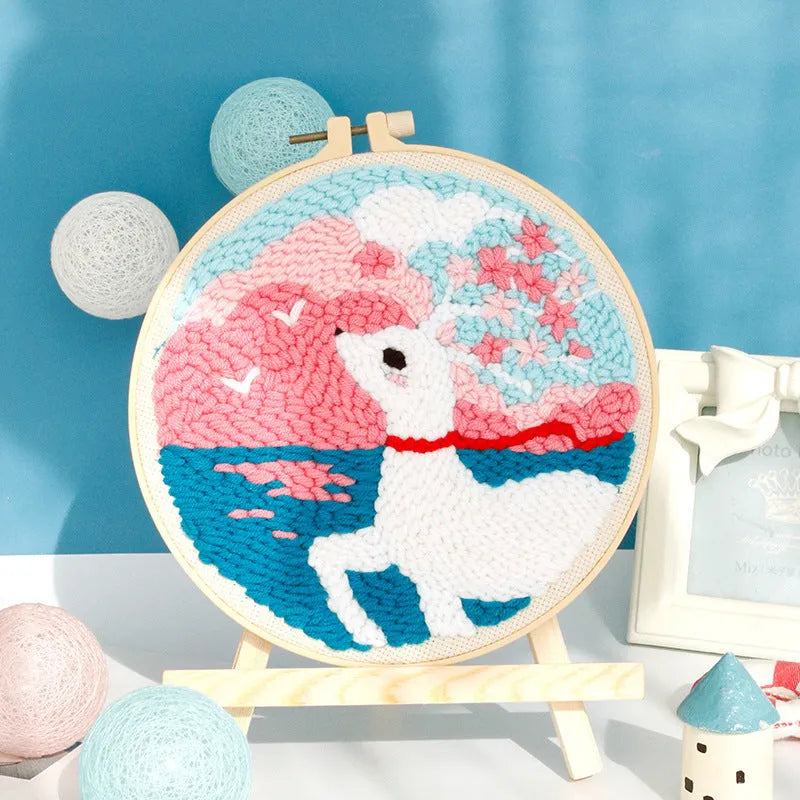 Handmade embroidery kit with cartoon animal designs on linen fabric including flamingo, whale and deer patterns