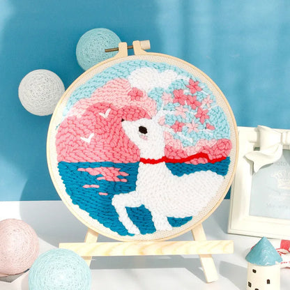 Handmade embroidery kit with cartoon animal designs on linen fabric including flamingo, whale and deer patterns