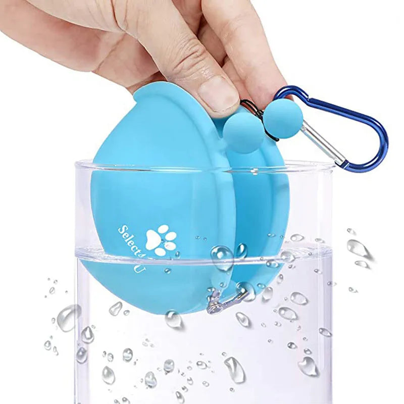 Yellow silicone dog training treat pouch with hook and loop closure, shown on a waistband.