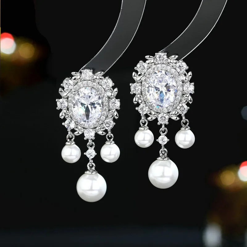Oval geometric earrings with zircon inlaid details and pearl tassels in light purple colour