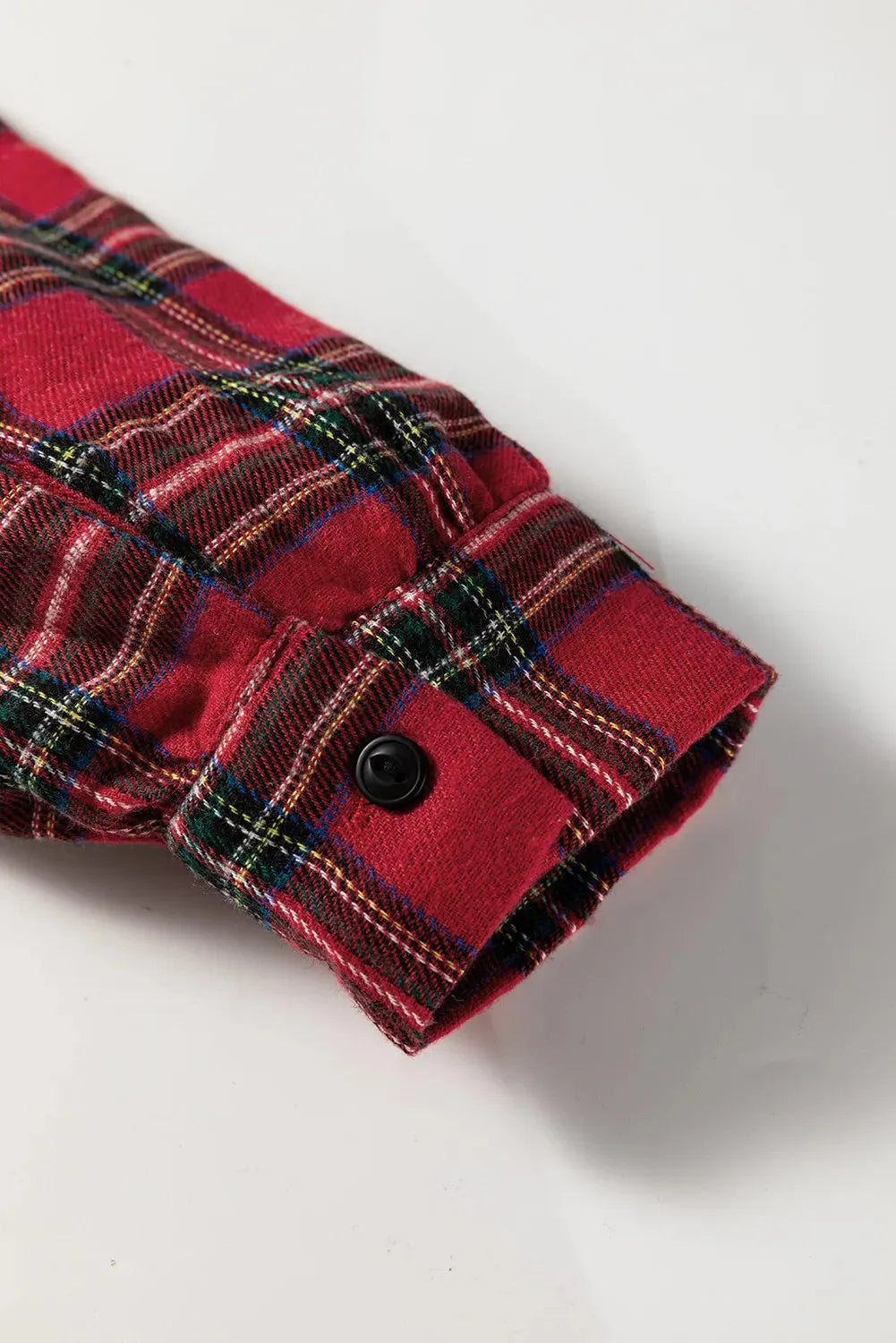Red plaid mini dress with shirt collar, half buttons, long sleeves, and ruffle hem