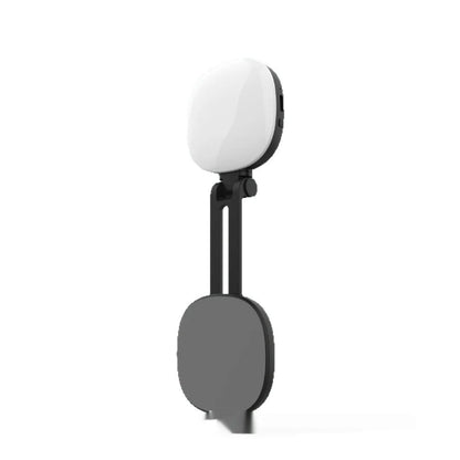 Black and white mini mobile phone fill light with magnetic holder attached to a smartphone