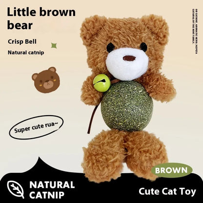 Brown bear plush cat toy with a small bell, showing soft texture and size next to a cat for scale.