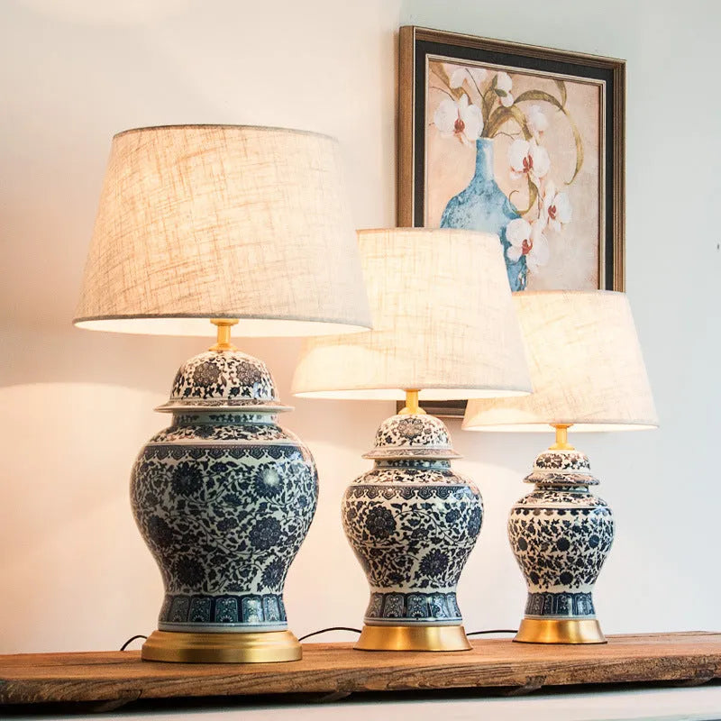 Chinese blue and white porcelain table lamp with cloth shade on bedside table