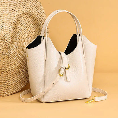 Genuine cowhide leather women's bucket bag in retro style with contrast stitching.