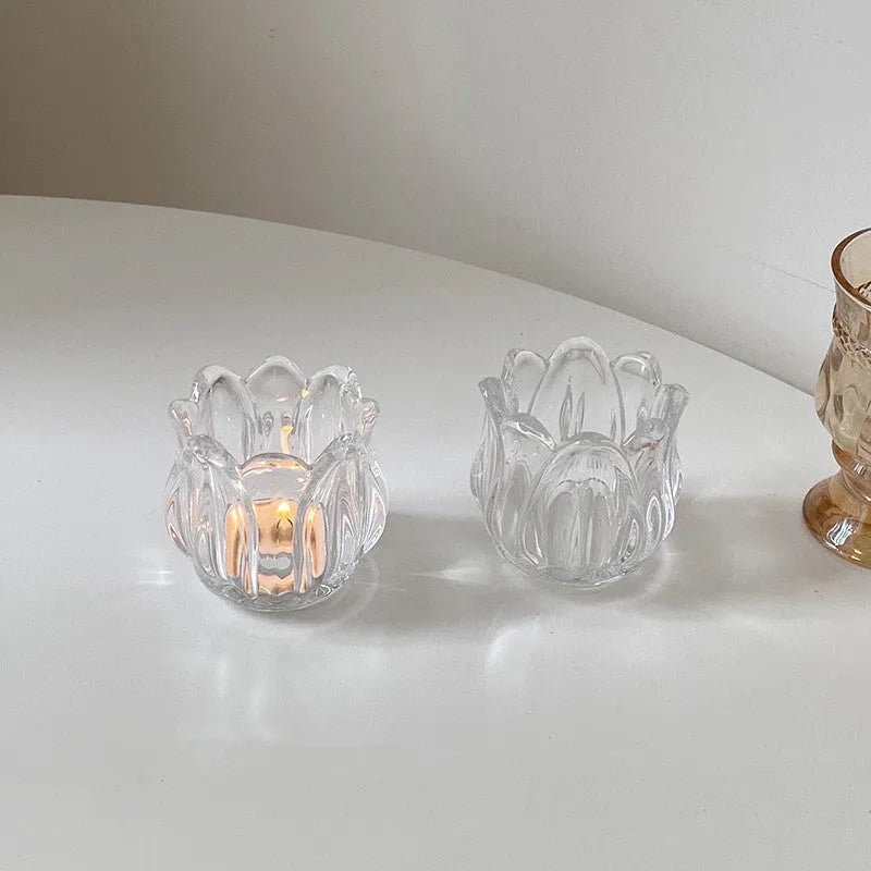 Transparent glass tulip candle holder with classic tumbler base on table