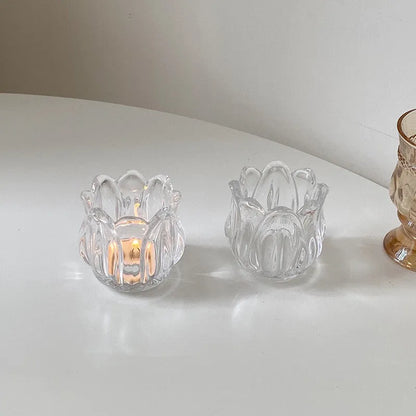 Transparent glass tulip candle holder with classic tumbler base on table