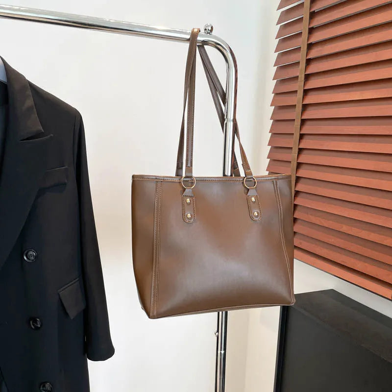 Korean style black PU leather shoulder underarm bag with a horizontal square shape and sandwich pocket.
