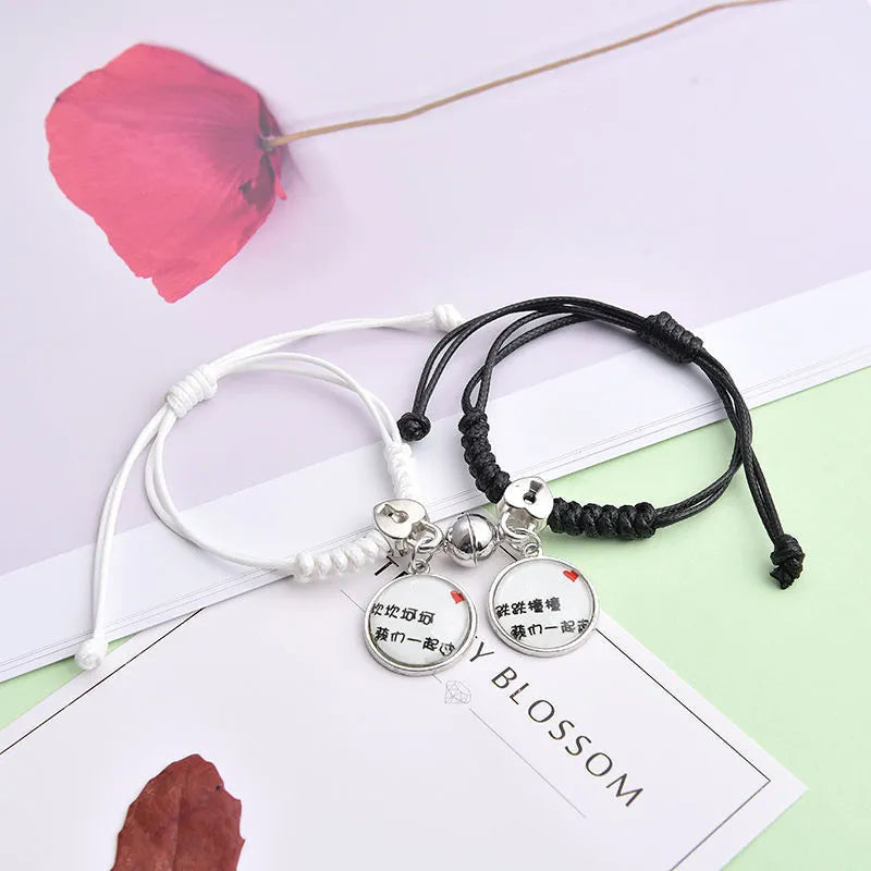 A pair of magnet couple bracelets with a suction clasp, showing various design options like clovers, crowns, and hearts.