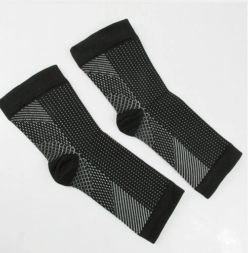 Anti-fatigue compression foot sleeve in black, red, or white, featuring moisture-wicking fabric and a heel hole for breathability.