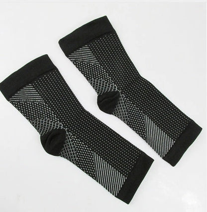 Anti-fatigue compression foot sleeve in black, red, or white, featuring moisture-wicking fabric and a heel hole for breathability.