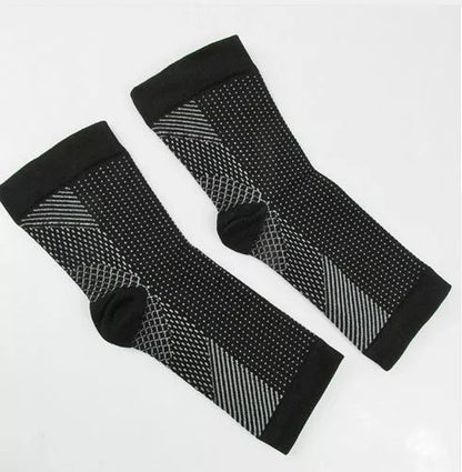 Anti-fatigue compression foot sleeve in black, red, or white, featuring moisture-wicking fabric and a heel hole for breathability.