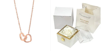 Rotating rose jewellery gift box with a preserved red rose under a clear acrylic dome, showing the interior rotating drawer.