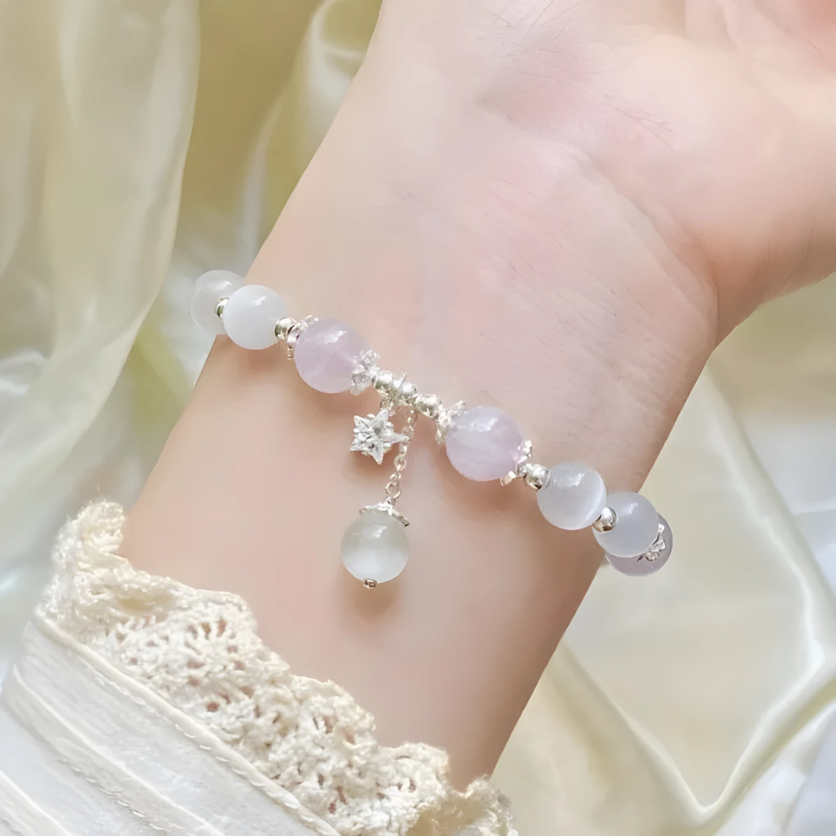 Moon-shaped women's bracelet with large opal amethyst crystal beads on wrist.