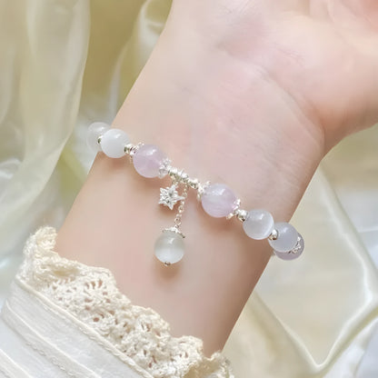 Moon-shaped women's bracelet with large opal amethyst crystal beads on wrist.